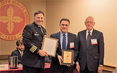 Captain Mark Vandroff (left) of the United States Navy and Glenn L. Martin Institute Professor of Engineering and Professor of Practice Millard S. Firebaugh (right) stand with Dr. Ayyub.
