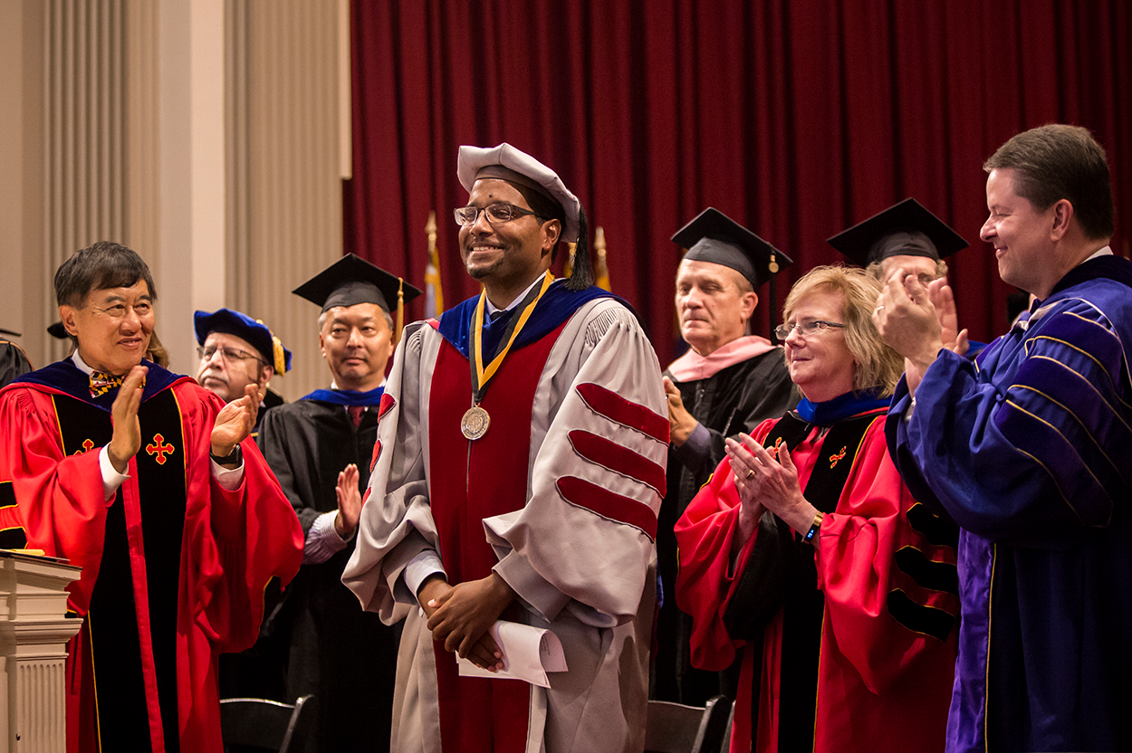 UMD President Wallace Loh (left) and colleagues give Clark School Dean Darryll Pines (center) a standing ovation at the 2018 Faculty and Staff Convocation. Photo: Stephanie Cordle