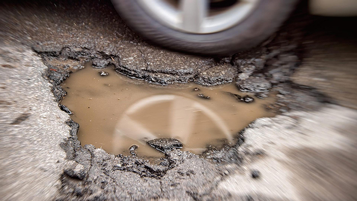 Fluctuating winter temperatures and lots of precipitation are the recipe for potholes.(Photo by iStock)
