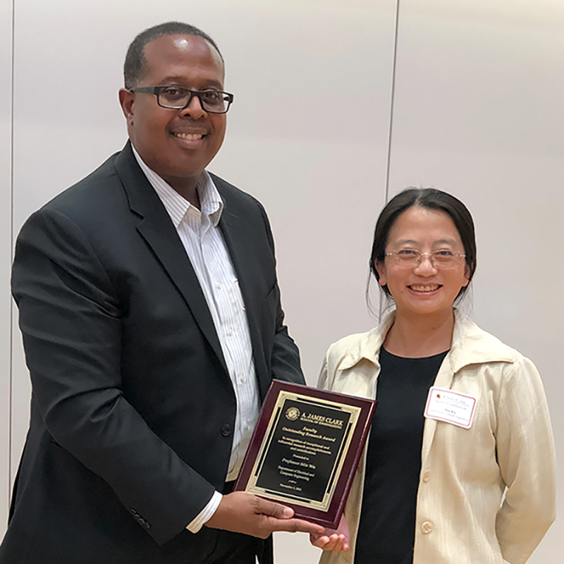 Dean Samuel Graham presents Min Wu with the Senior Faculty Outstanding Research Award.