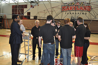 UMD President Darryll J. Pines (left) and Alfred Gessow Professor of Aerospace Engineering Inderjit Chopra (third from left) talk with students involved in the Gamera human-powered helicopter project in 2013. The UMD-designed helicopter broke world records for flight duration and flight duration by a female pilot.