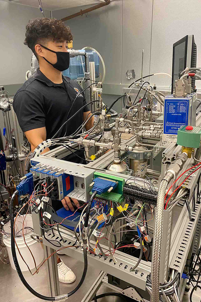 Undergraduate engineering student Jangho Yang '24 works with emerging heating and cooling technology in the lab.
