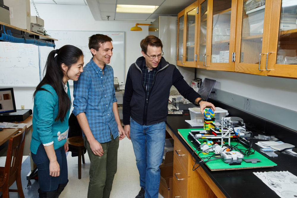 Andersson, his grad students and a Lego-based atomic force microscope demonstrator system. Photo courtesy Boston University.