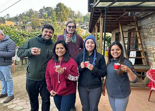 UMD Global STEWARDS Amir Riyahi, Camila A. Proano and Maia Karpovich along with local guides Neecal Shreshtha and Rupa Dhital enjoy lemongrass tea on a crisp morning at Sanskriti Farms and Research Centre.