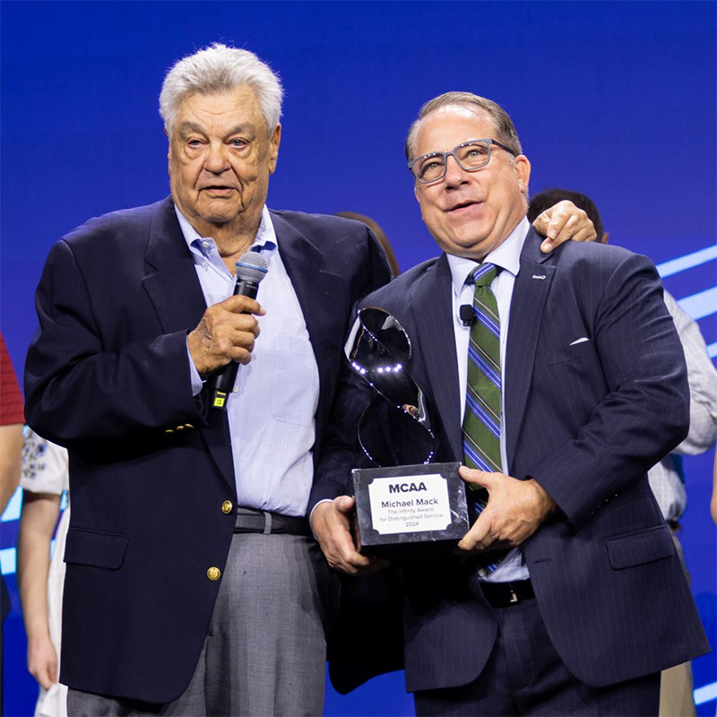 Michael Mack (right), pictured here with former MCAA President Robert Beck, received the 2024 MCAA Distinguished Service Award during the organization's annual convention in Orlando.