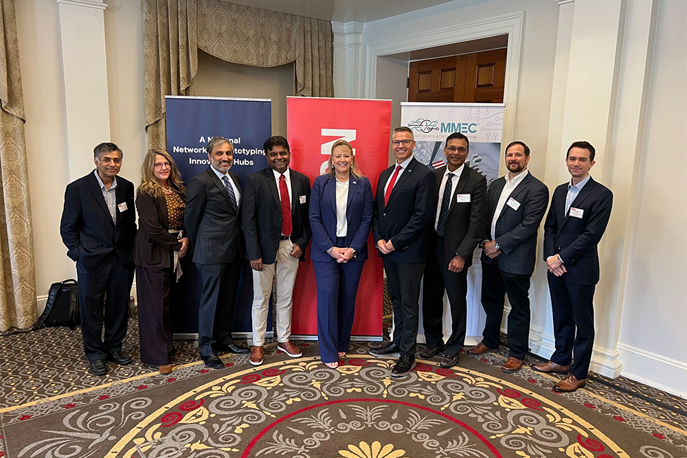 Institute for Systems Research Director Ankur Srivastava (third from left); Midwest Microelectronics Consortium (MMEC) CEO Jackie Janning-Lask (center); MMEC Chief Technology Officer Matt Casto (fourth from right); and other MMEC members.