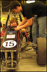 Terps Racing team member Mark Bellingham assists Beltsville, Maryland Scout in the 2007 formula car.