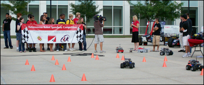 A television crew from WTTG Fox 5 in Washington, D.C., films students' robots live from the Kim Building plaza.