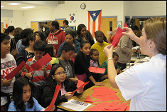 Lina Castano, aerospace PhD student, conducts a paper airplane demo with students.