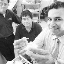 Jie Chen, left, Ying Tsui and Tarek El-Bialy with a model of the ultrasound device. Photo credit: Shaughn Butts, The Edmonton Journal