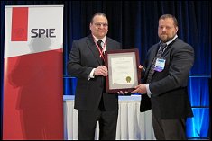 Prof. Wereley, on behalf of the TSI/UMD SAMSS Development Team, accepts the SPIE Smart Structures Product Implementation Award presented by Dr. Kevin Farinholt.