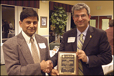 Professor Ashwani K. Gupta receives the A. James Clark School of Engineering Outstanding Research Award from Clark School Dean Nariman Farvardin.