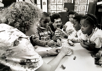 Dr. Denice Denton (L) and her graduate student Reza Ghodssi (C) share engineering concepts with children at the University of Wisconsin in the early 1990s.