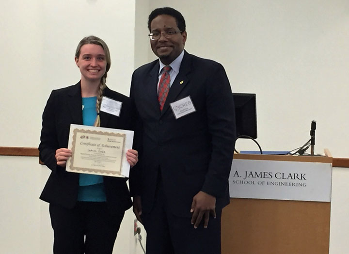 Dean Darryll Pines congratulates undergraduate Sabrina Curtis winner of poster contest