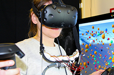 A prototype device attached to a virtual reality headset wafts scents toward the nose of Andrea Batch, a doctoral student in information studies developing technology to integrate smell into VR technology.(Photo courtesy of Andrea Batch and Biswaksen Patnaik)