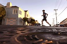 Runner and writer Rickey Gates pounds the pavement through San Francisco. High school buddy Michael Otte, below, assistant professor of aerospace engineering, used his research background to help seek efficient routes. Gates' completed run on every street in the city is traced in blue on a Strava heat map.
(Running photo and map courtesy of Rickey Gates; Michael Otte photo courtesy of Clark School of Engineering)