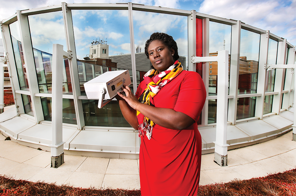 Associate Professor Akua Asa-Awuku holding a compact ozone monitor. Photo: John T. Consoli