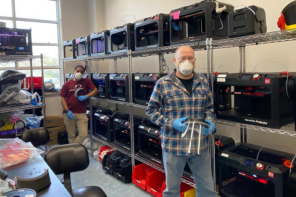 Terrapin Works staff Nathanael Carriere (left) and Andy Gregory attend banks of 3D printers turning out protective gear and other equipment for front-line personnel fighting the pandemic. (Photos courtesy of Terrapin Works)