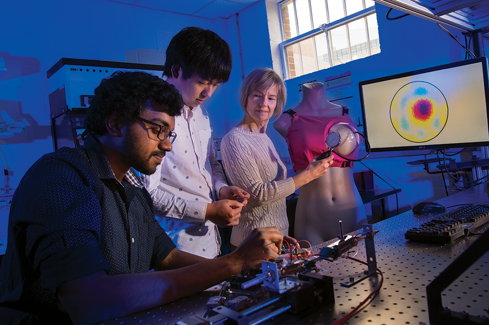 From left to right: Master's student Rahul Subramonian Bama, undergraduate Hudson Ye, and Professor Elisabeth Smela with their 