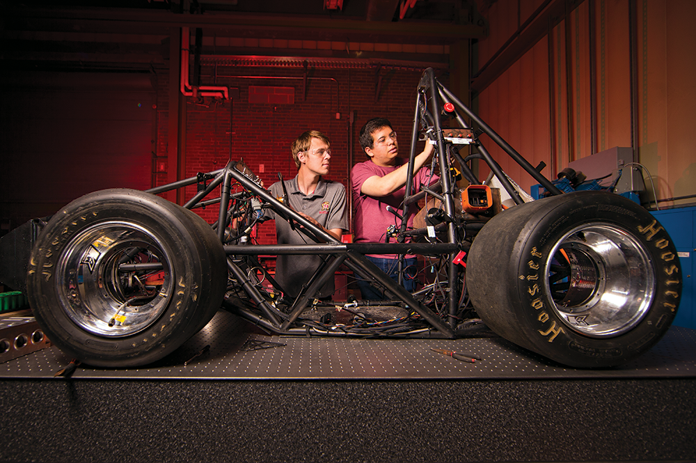 Terps Racing members Preston Der (left) and Garrison Case with the electric racecar. Photo: John T. Consoli