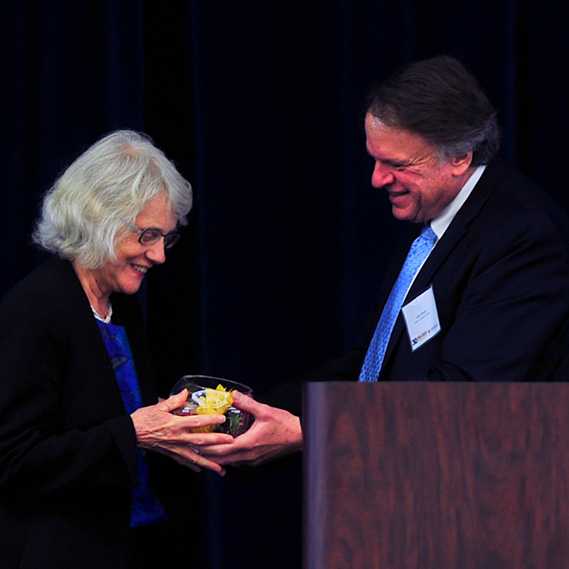 Lynn Preston (l) receives a gift of appreciation from John Baras at ISR's 30th anniversary celebration in 2015.