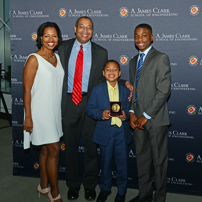 Jones family posing for a formal picture at a distinguished alumni event