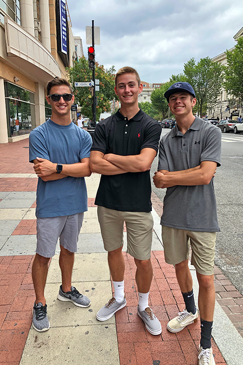 Three male engineering students who participated in a Women in Engineering living-learning community posed together.