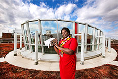 Associate Professor Akua Asa-Awuku holds a compact ozone monitor on the roof of the Physical Science Complex