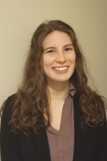 Headshot of Marisa Patsy in business attiture, smiling against a white wall