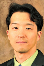 Headshot of Jin-Oh Hahn, taken in front of a brown background