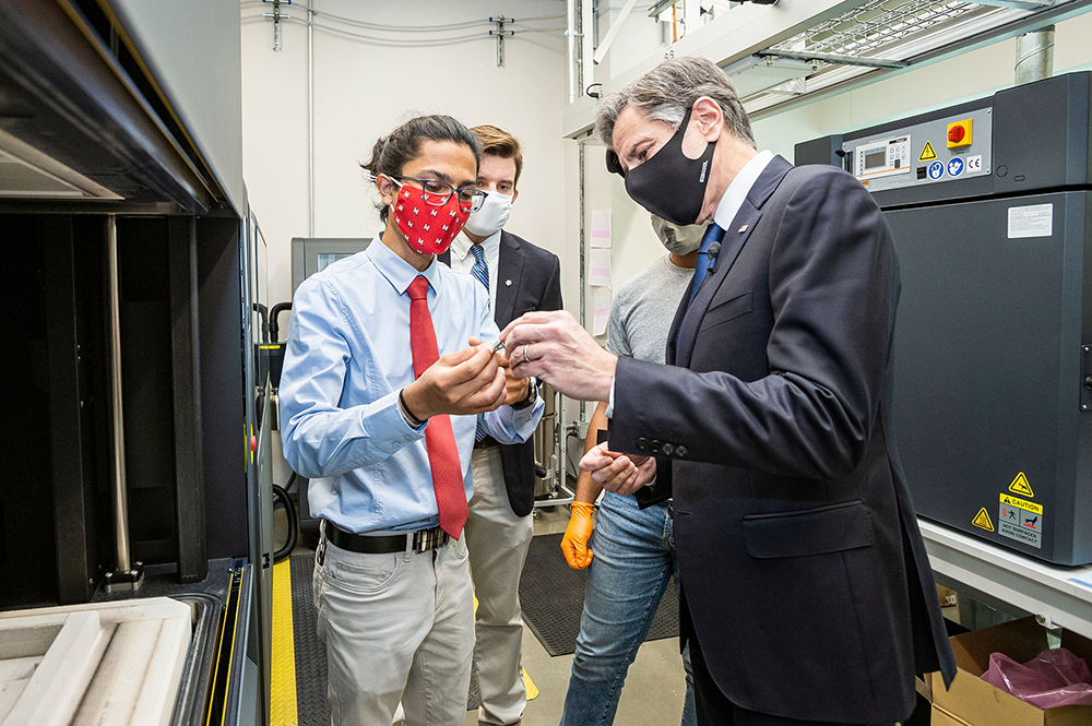 An engineering student explains 3D printing to Secretary of State Antony Blinken in the Advanced Fabrication Lab.