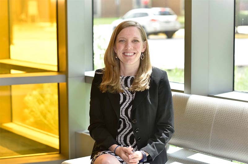 Dr. Kim Stroka sits in front of a window in A. James Clark Hall at the University of Maryland.