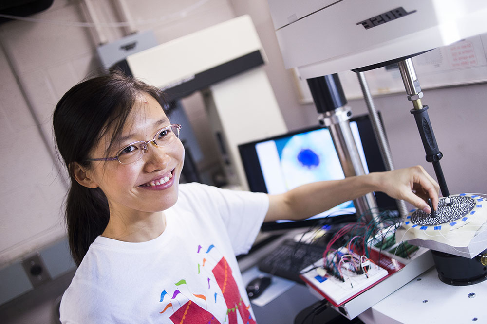 Ying Chen, a PhD graduate in mechanical engineering, works on a Smart Bra project led by Drs. Elisabeth Smela and Miao Yu. Chen is pictured working in the lab of Dr. Hugh Bruck, a collaborator on the project.