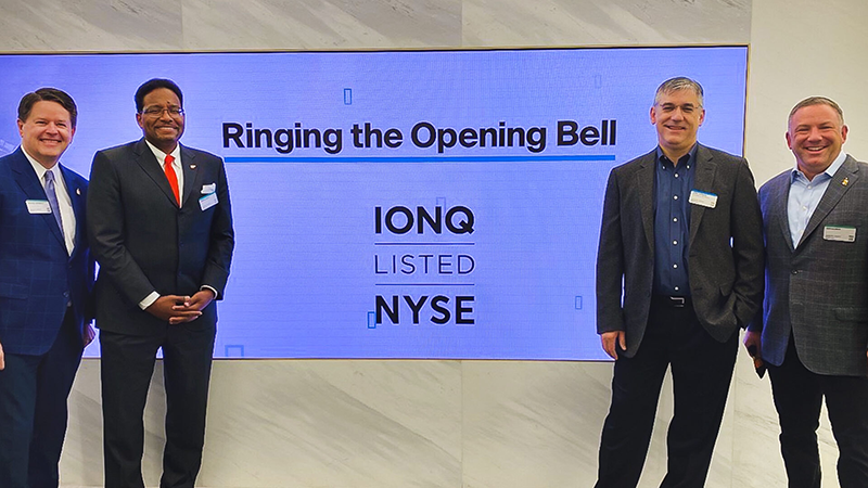 The UMD contingent joining IonQ officials at the New York Stock Exchange Friday for the ceremonial opening bell-ringing included Vice President for Legal Affairs and General Counsel Mike Poterala (left), President Darryll J. Pines, College Park Professor of physics and IonQ co-founder and chief scientist Chris Monroe, and Chief Strategy Officer for Economic Development Ken Ulman.