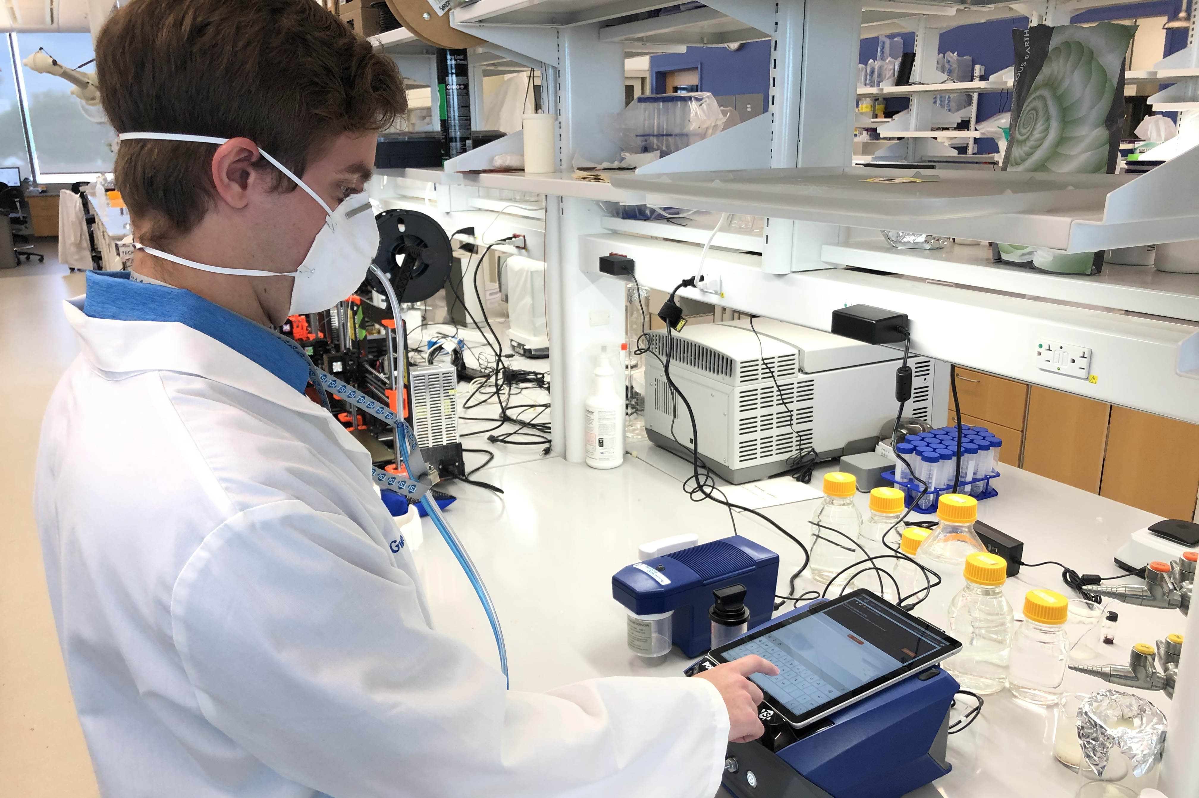 Quinn Burke, a bioengineering graduate student and an MPower fellow with the Fischell Institute, uses a TSI Portacount Respirator Fit Tester to conduct a quantitative fit test.