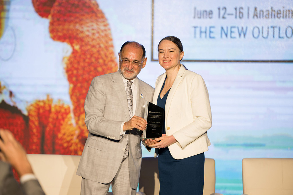 Hash Hashemian (lefr), chair of the ANS Honors and Awards Committee, presents the Landis Young Member Engineering Achievement Award to UMD assistant professor of mechanical engineering Katrina Groth.