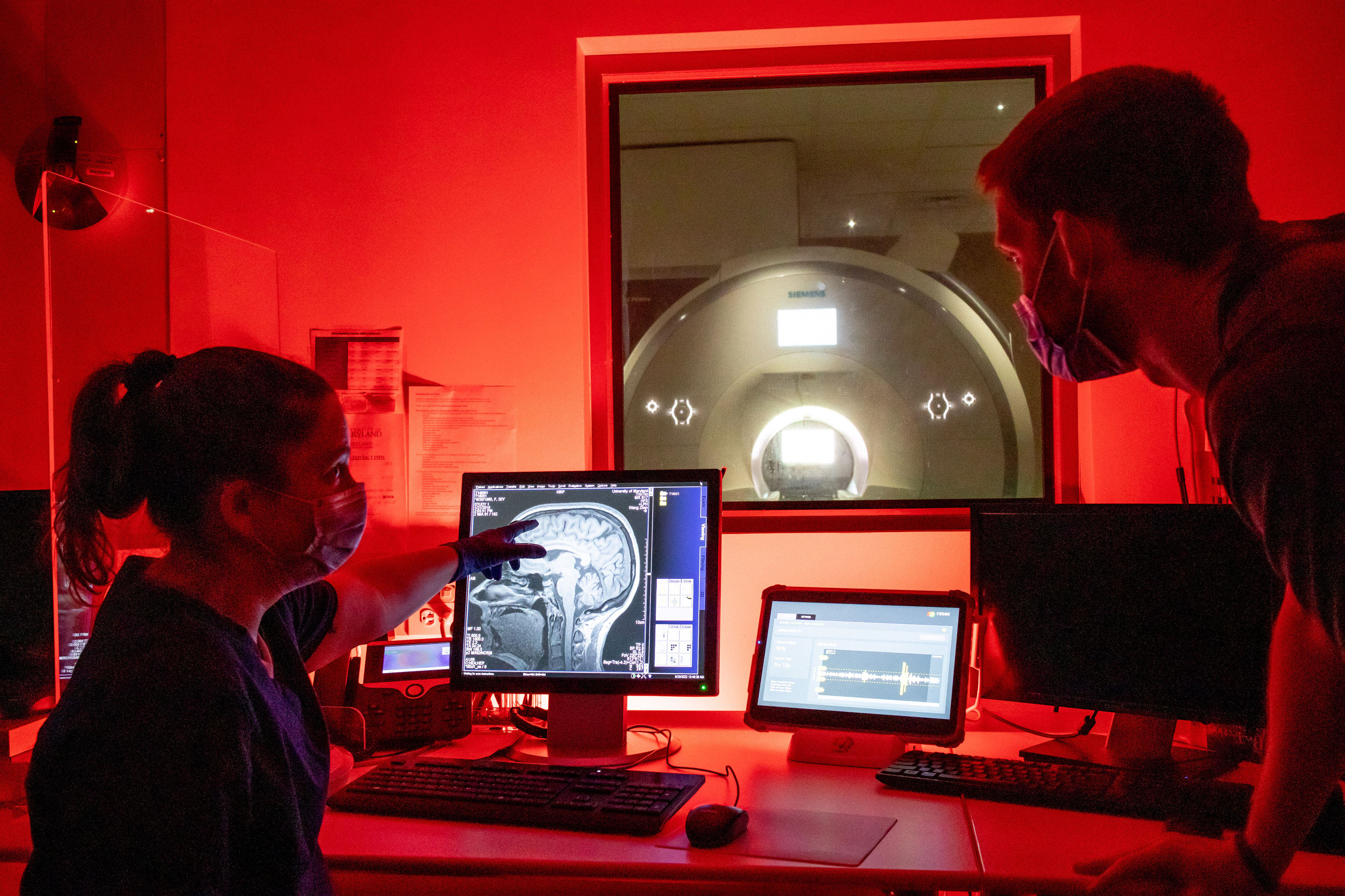 Magnetic resonance technologist Christie Rebsch and Ph.D. candidate Daniel Callow examine an MR image of the human brain at the Maryland Neuroimaging Center. Photo by Nathaniel Underland.