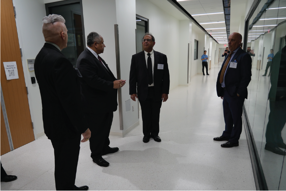 Matt Scassero, Navy Secretary Del Toro, and Dr. Ghodssi in front of Mechanical Engineering Lab