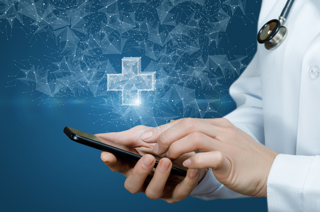Stock image of a doctor's hand holding a cell phone. Graphic elements on the image portray the idea that the future of medical care involves medical care administered via a mobile device.
