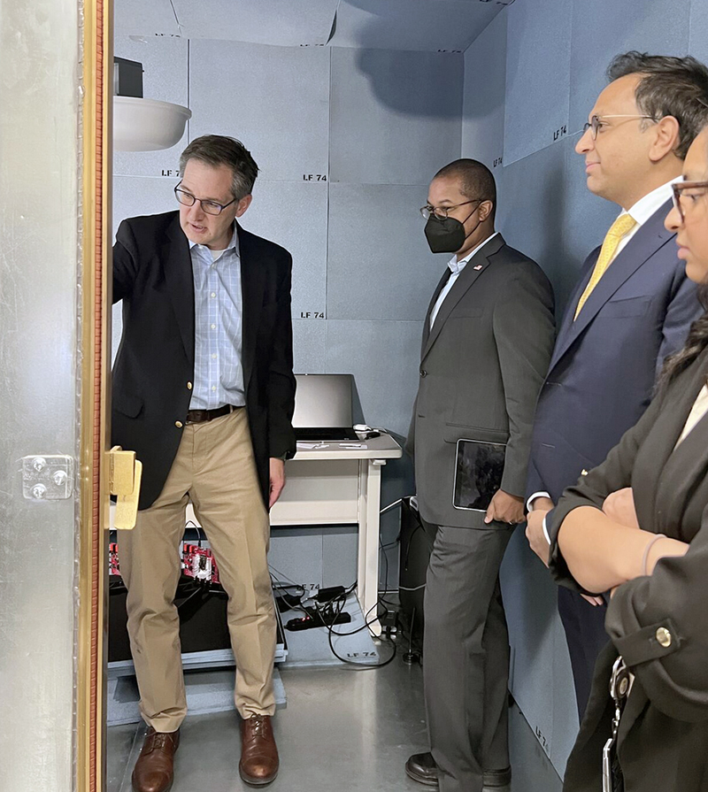Inside the 5G Secure Test Bed, ISR Visiting Research Engineer Wayne Phoel (left) explains the experiments he is conducting to FCC Commissioner Geoffrey Starks (center).