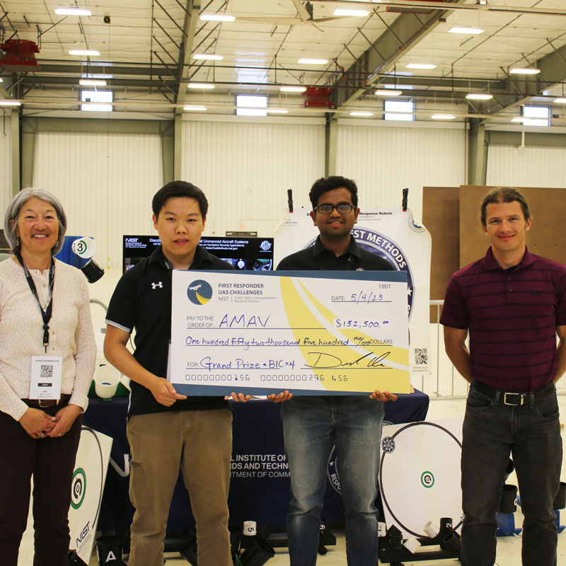 Center, team members Animesh Shastry (right, Ph.D. student, aerospace engineering), Team Lead and Qingwen Wei (left, senior, aerospace engineering), Co-Lead, Design Lead and Pilot with NIST UAS Challenge Team Members; not pictured, team members Jeffin Kachappilly (M. Eng. Student,  robotics), Software Developer and Henry Segal (undergraduate, Computer science & math), Software Developer not pictured). Photo courtesy of NIST.