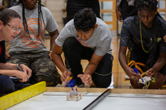 Nazareth Hernandez from Duval High School releases his winning cart down a white ramp