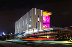 exterior of the IDEA Factory lit up at night