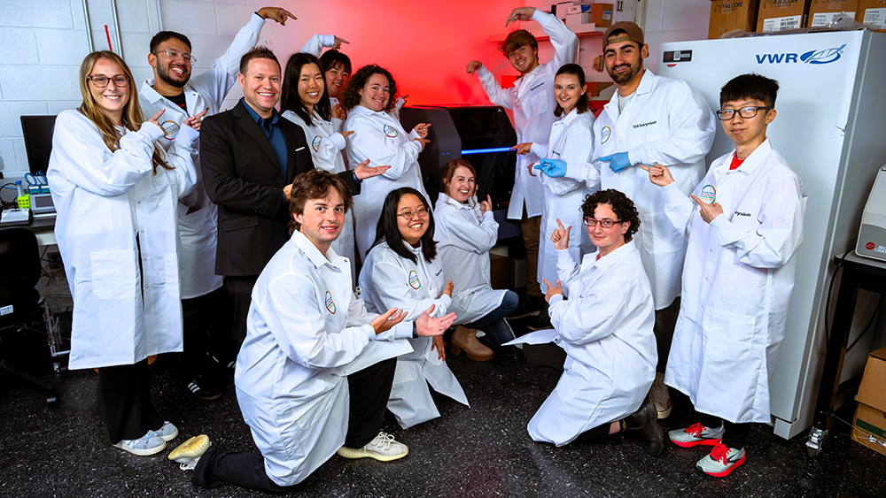 Team members in Associate Professor Ryan Sochol’s Bioinspired Advanced Manufacturing Laboratory pose with their newly acquired 3D nanoprinter.