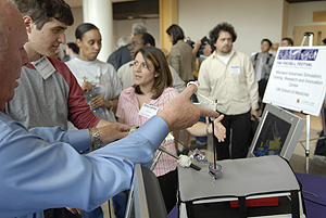 A representative of the University of Maryland School of Medicine's Advanced Simulation, Training, Research and Innovation Center demonstrates a computer-assisted surgical training device at the Fischell Festival's bioengineering career information fair. Photo by Al Santos.