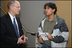 Ray O. Johnson speaks with a student after his talk. (Photo by Al Santos)