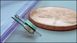 A model of an autonomous jumping robot, with a penny for scale. Photo by Sarah Bergbreiter.