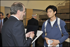 William Brody, president of Johns Hopkins University, speaks with a student after his lecture (Photo by Al Santos).