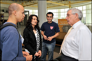 Department benefactor Dr. Robert E. Fischell (M.S. '53, right) talks to students during the Festival's research poster session.