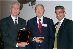 Bissell receives his Academy medallion in 2003 from chair William Fourney and Dean Nariman Farvardin